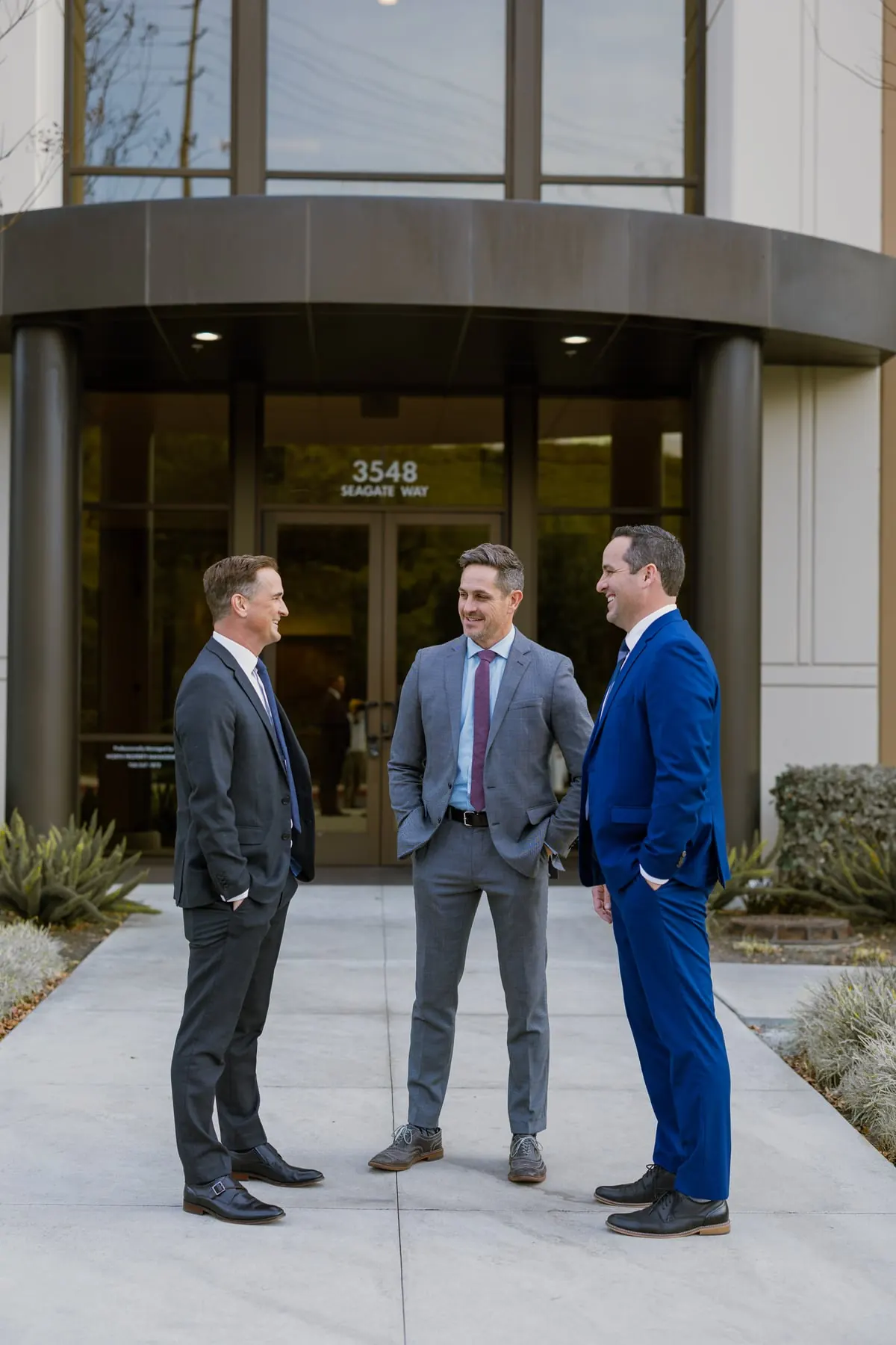 Jeff Yates, Derek Waldron, and Jeff Waldron in conversation outside the Devoted Injury Lawyers Oceanside, CA office at 3548 Seagate Way