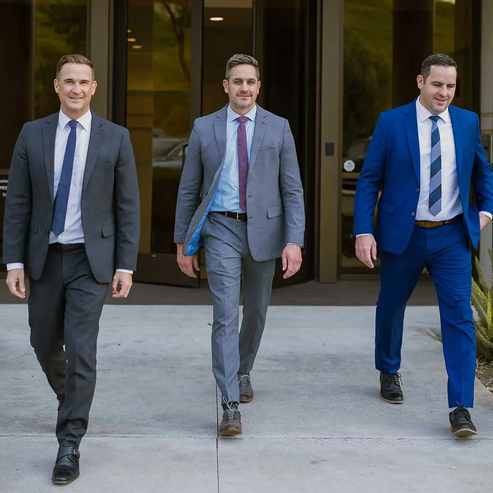 The Devoted Injury Lawyers team - Jeff Yates, Derek Waldron, and Jeff Waldron walking out of the firm's Oceanside office